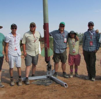 Students pose with rocket
                  