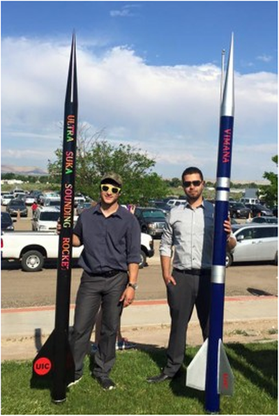 Students holding rocket entries