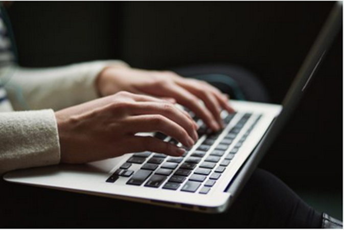 Person typing on laptop