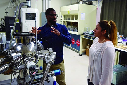 Professor Abiade lectures student at lab