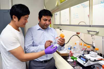 Professor Anand and assistant doing experiment