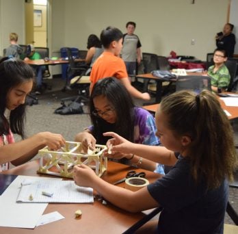 Young students building a rectangular structure 