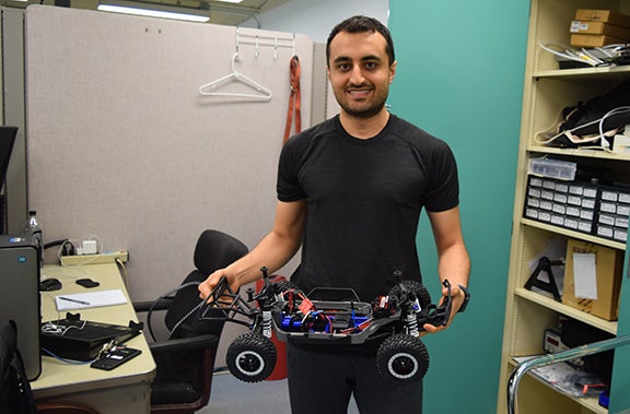 Student holding car prototype