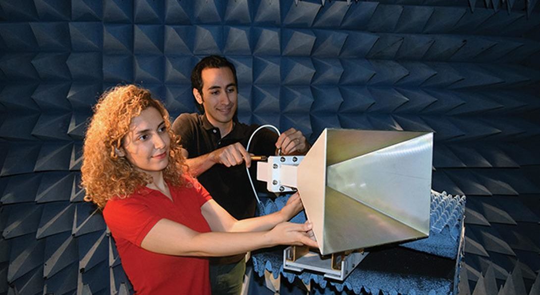 Seiran Khaledian and Farhad Farzami adjust an amplifier