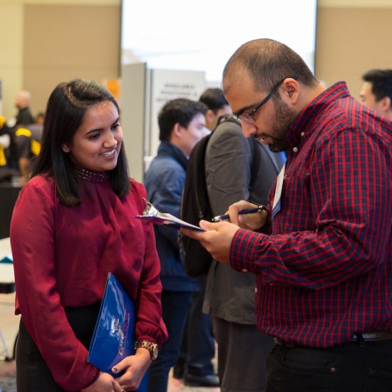 student talking to employer at career fair