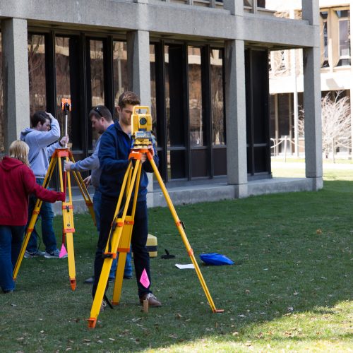 students standing at tripods