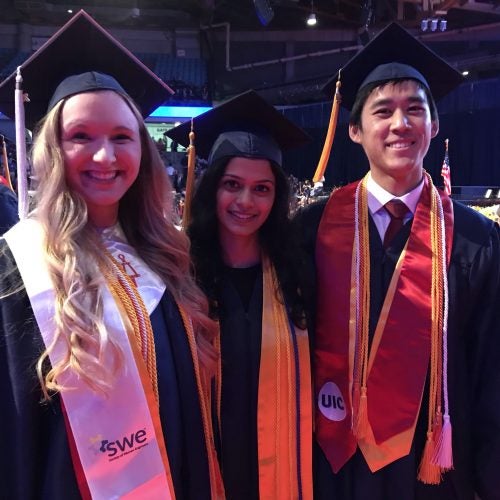 three students at graduation