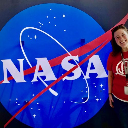 student posing with NASA logo