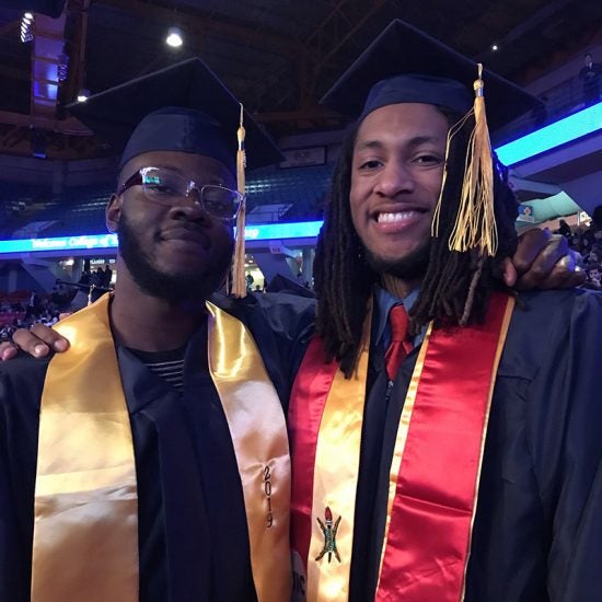 two students at commencement ceremony