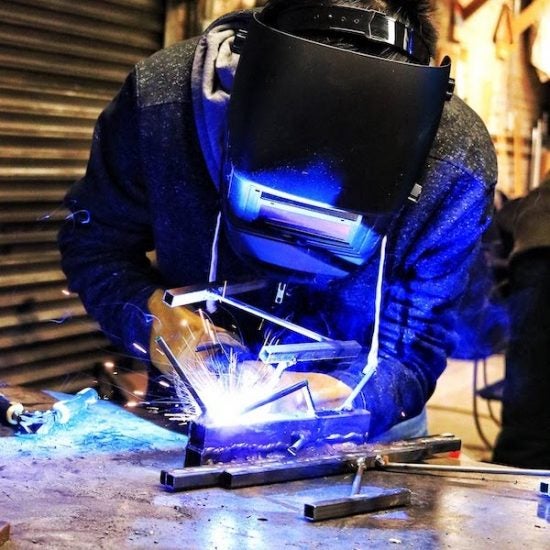 Student welding in the MakerSpace