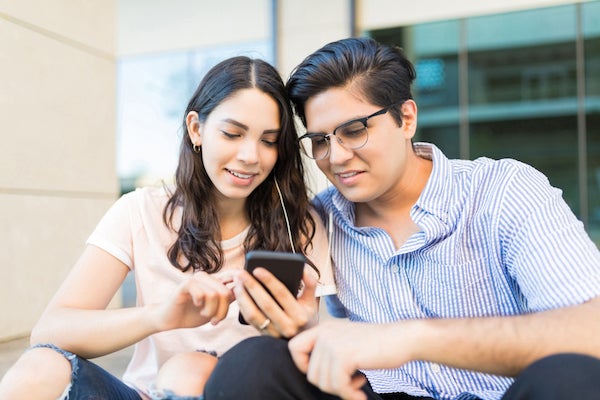 people look at phone listening to music