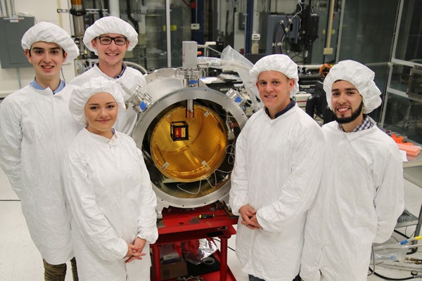 Team in front of vessel in Fermilab's cleanroom