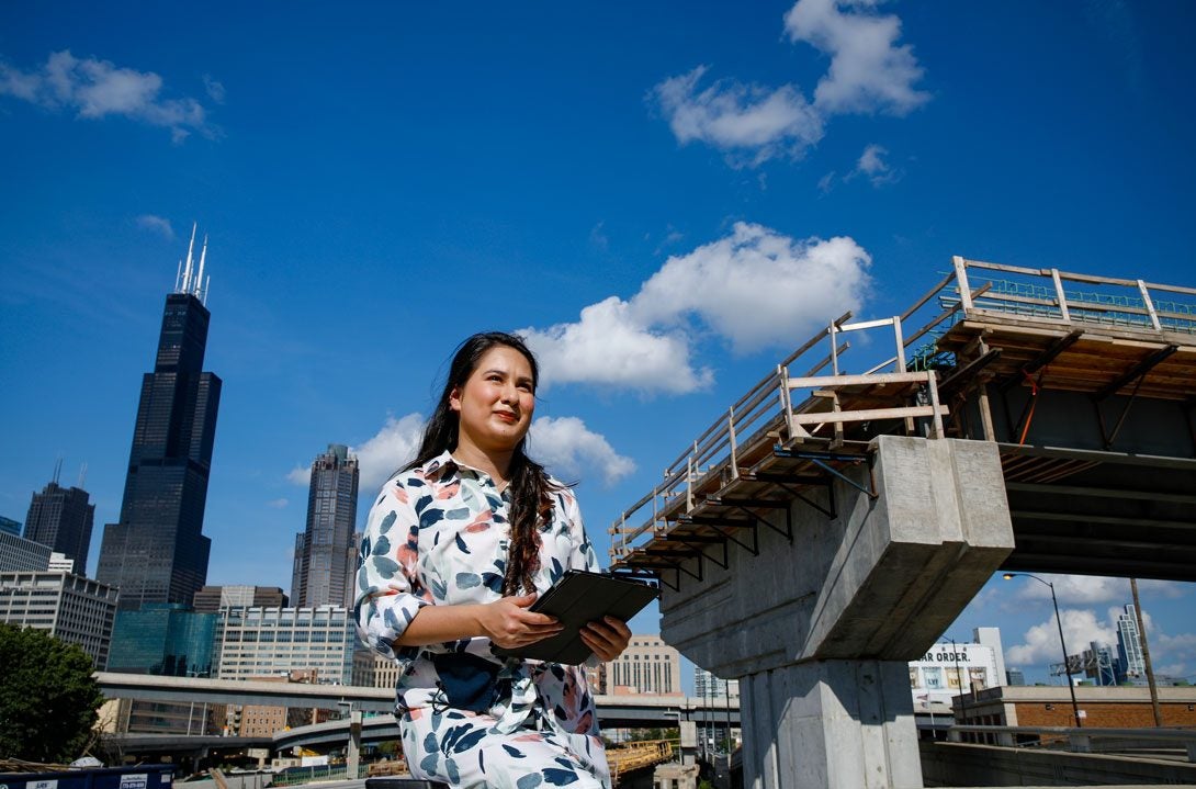 Alumna Diana Briones in front of the Jane Byrne Interchange