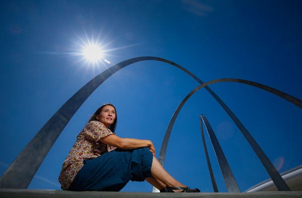 Miiri Kotche sitting beneath a sculpture