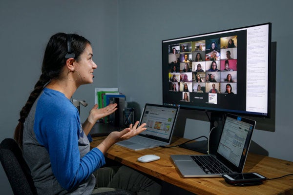 Person sitting at a workstation facilitating a virtual meeting