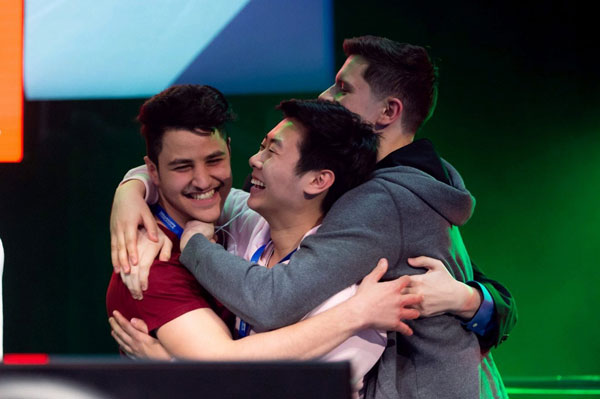 Team members from UIC's Competitive Gaming Club sharing a celebratory hug