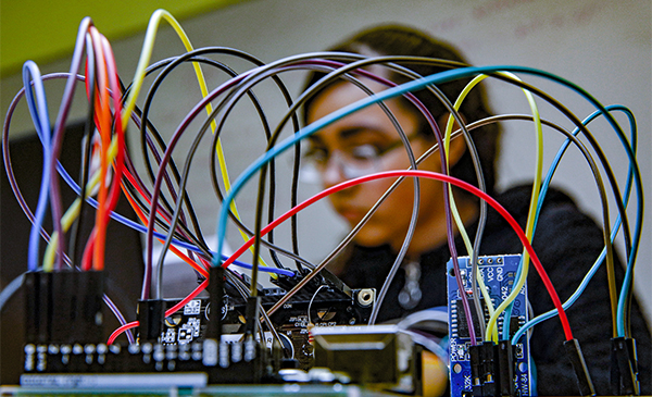 student with wires in Tinkering lab