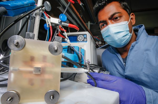 PhD student Nishithan C. Kani uses an electro-chemical reactor to form ammonia in a lab