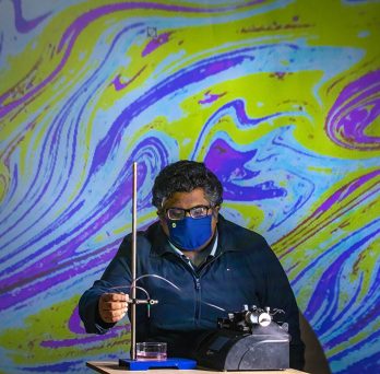 Varun Kulkarni, a post-doc researcher, investigating oil droplets in water 