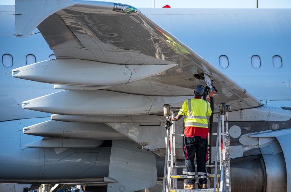 An airplane mechanic working on a plane