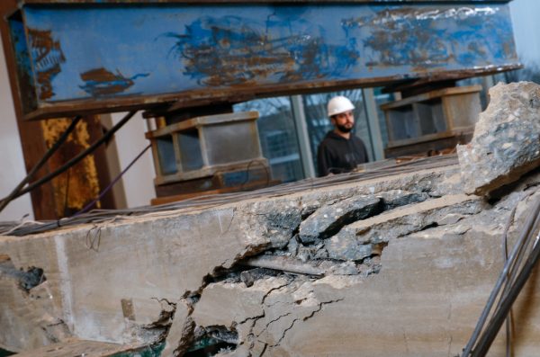 A person inspecting damaged infrastructure