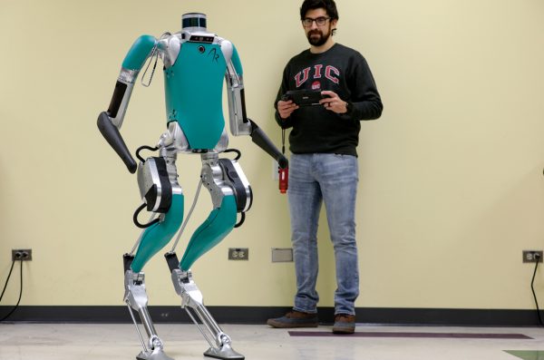 A student controlling a legged robot