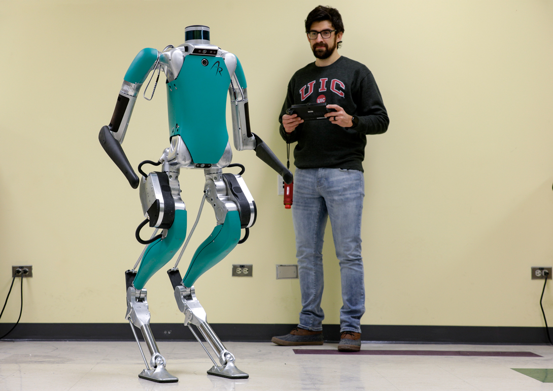 A student controlling a legged robot