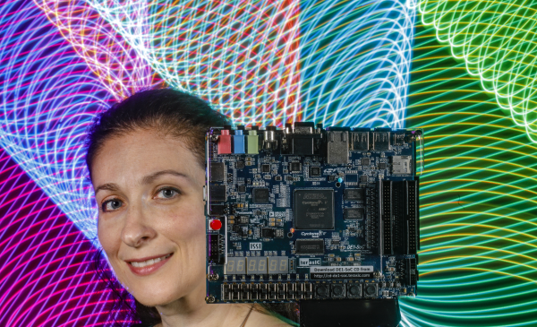 ECE professor Inna Partin Vaisband with a FPGA circuit board.