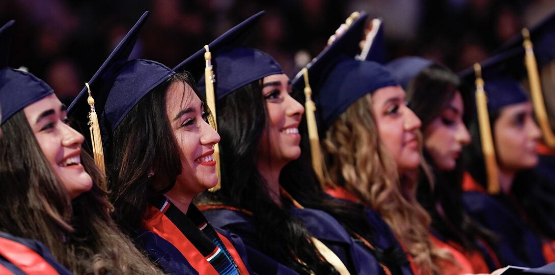 row of graduates smiling
