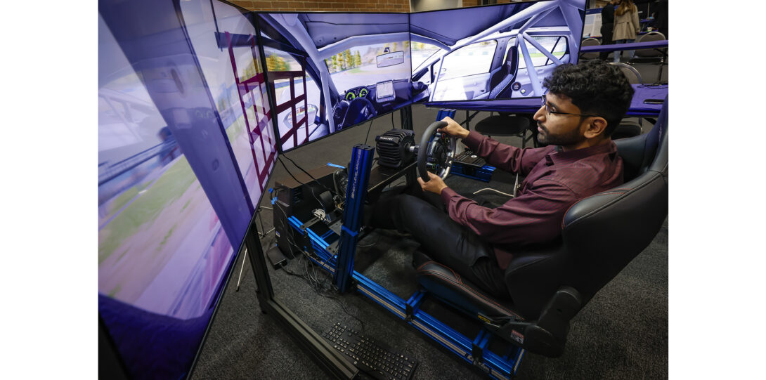 student drives car simulator