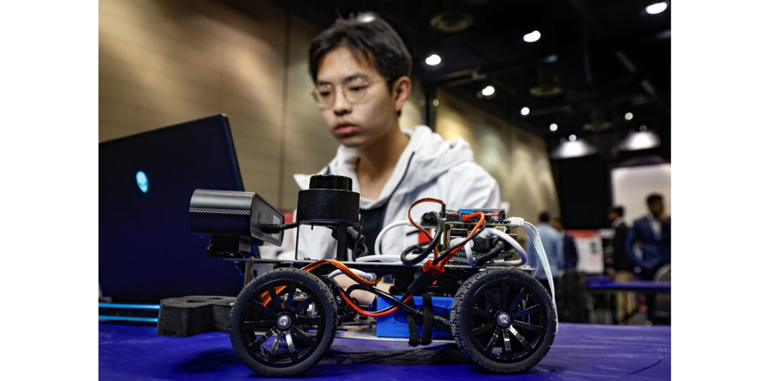 student with mini robotic car