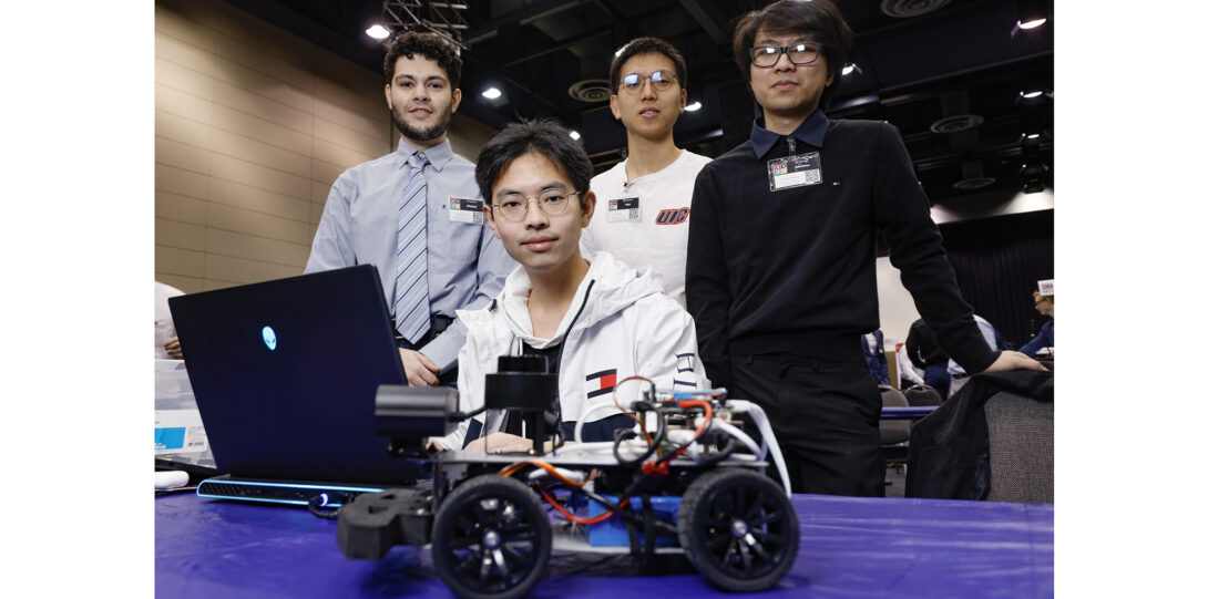 students poses with small remote controlled car