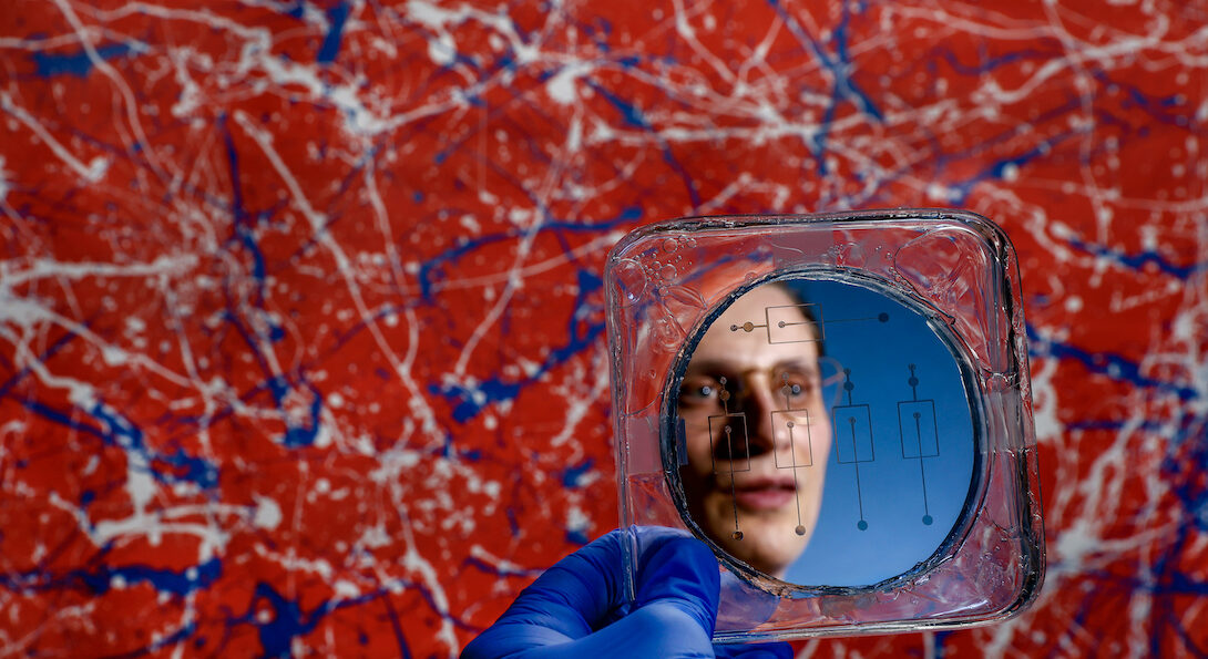 University of Illinois Chicago College of Engineering PhD student Michael Rogy reflected in a Microfluidic mold. Rogy won an NSF graduate fellowship.