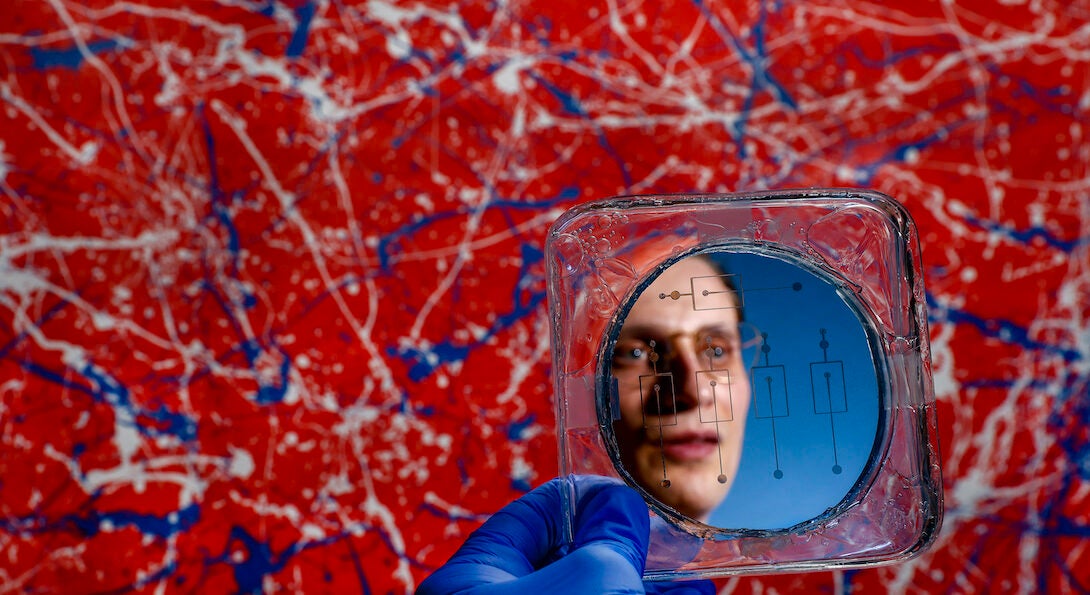 University of Illinois Chicago College of Engineering PhD student Michael Rogy reflected in a Microfluidic mold. Rogy won an NSF graduate fellowship.