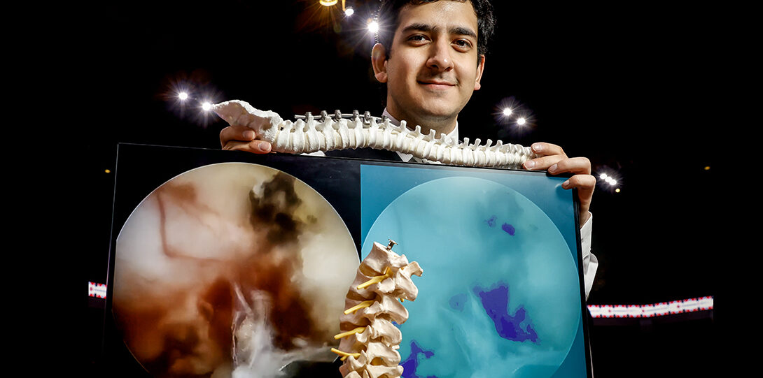 students holds model of human spine beside microscopic images