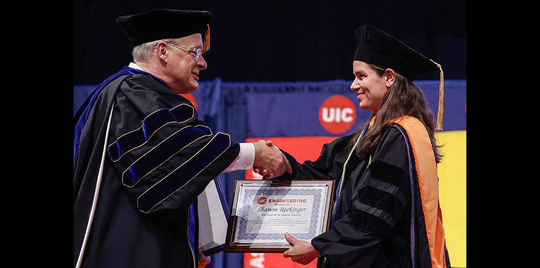 Dean Pete Nelson presents award to faculty member