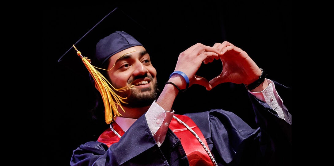 student making a heart sign with his hands