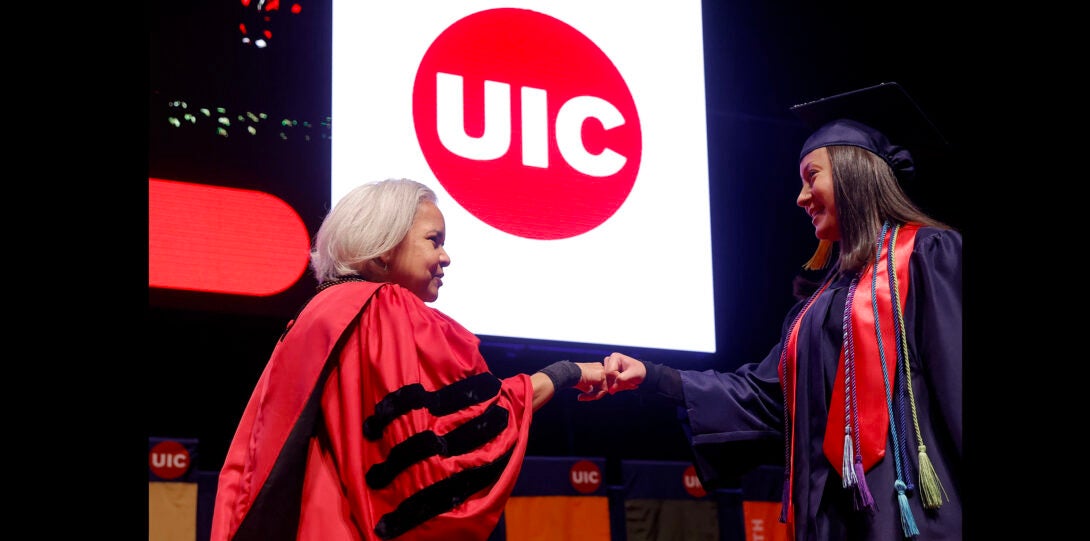 student shaking hands with chancellor