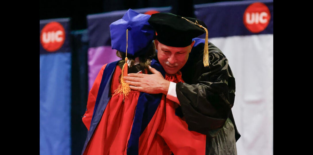 student receives hug from department head