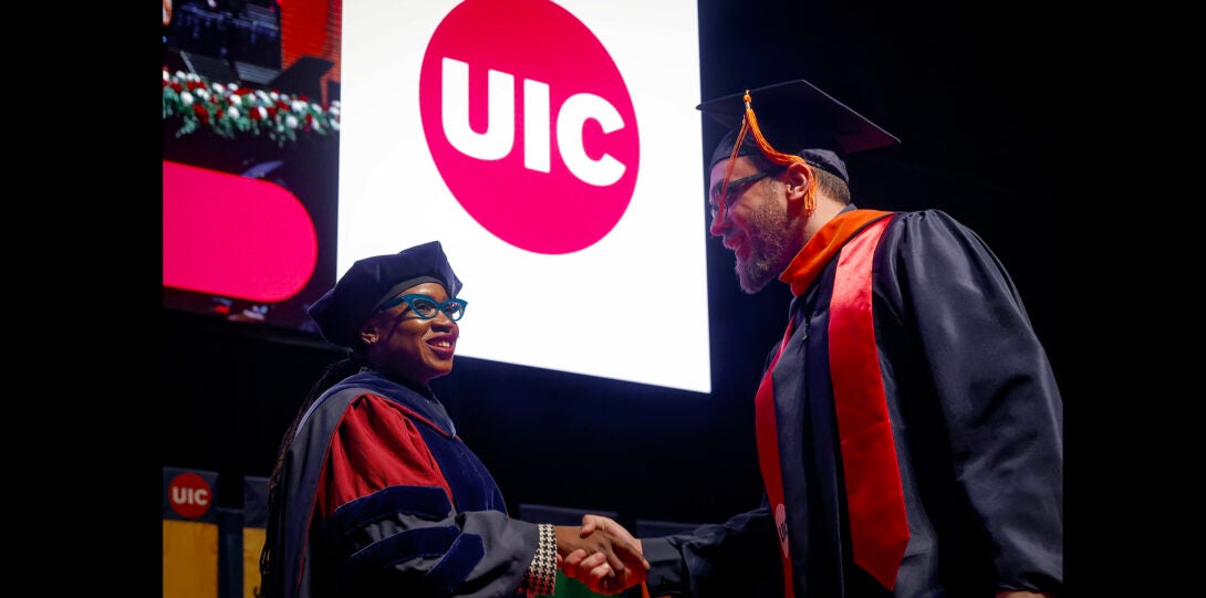 student shaking hands with the dean