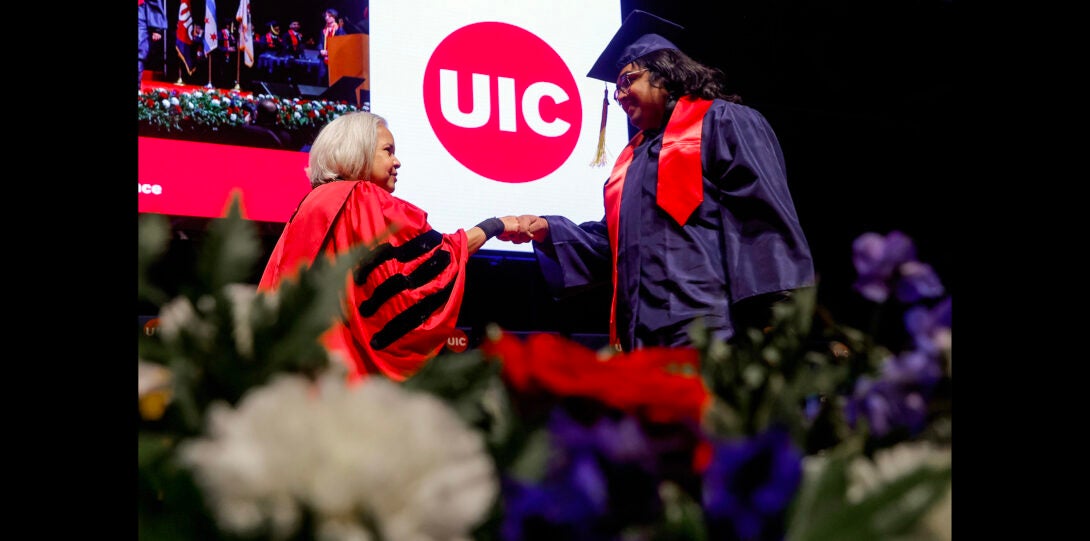 Chancellor shakes hand of graduate