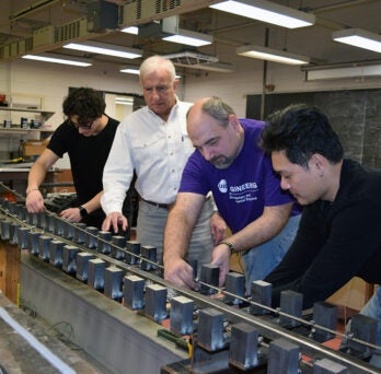 UIC Distinguished Professor and Christopher B. and Susan S, Burke Chair in Civil Engineering Farhad Ansari and his students work on a model of the Messina bridge in his lab at UIC 