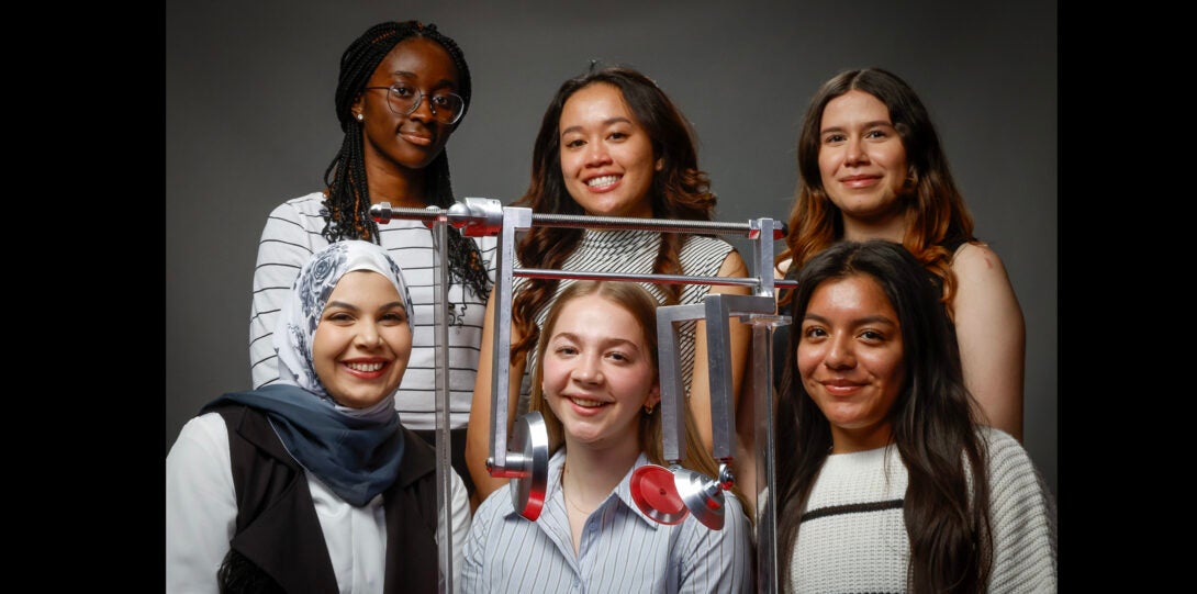 group of students pose for photo with their design project device
