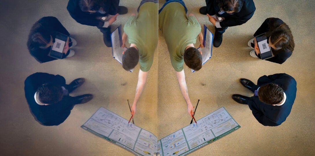 students and judges are reflected in a mirror during competition
