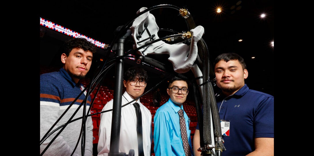 group of students pose for a photo with their design project