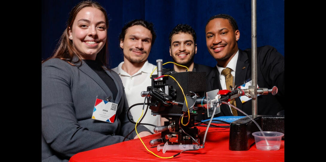 group of students pose for photo with equipment