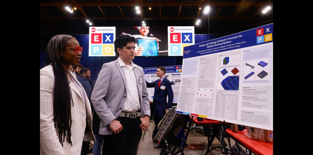 College of Engineering Dean speaks to student about their design project