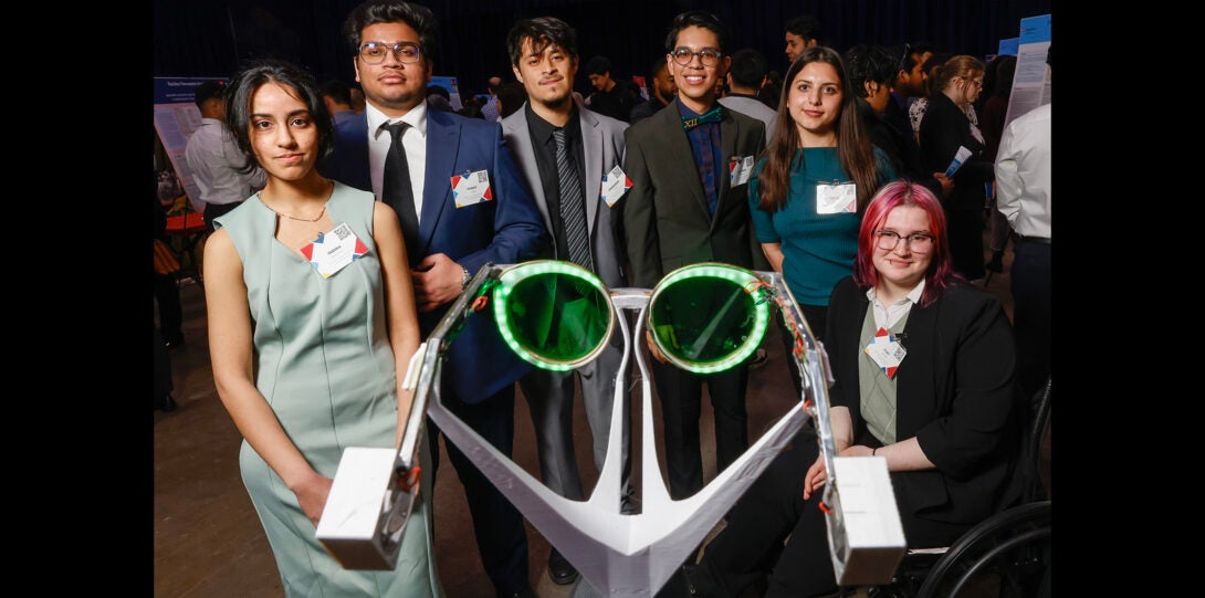 students pose for a group photo with eye glasses research project