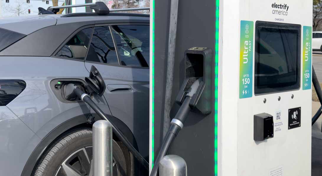 An electric vehicle gets a charge at an electric charging station