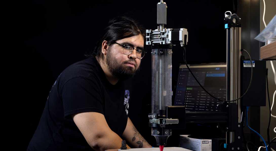 MIE Phd student Juan Alanis with a Direct Ink Writing (DIW) printer in professor Yayue Pan’s lab